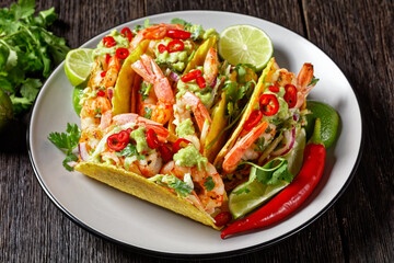 taco shells with shrimps on a plate