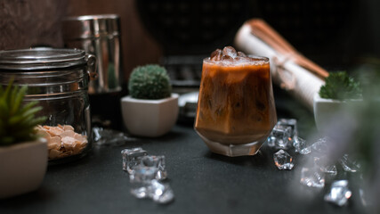 Close-up of iced coffee served on black table at cafe​