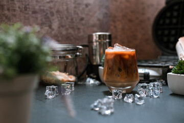 Close-up of iced coffee served on black table at cafe​