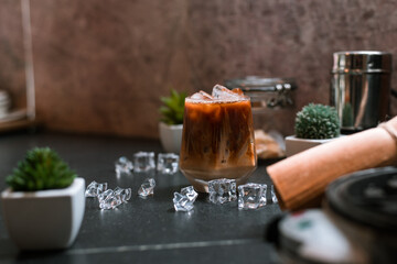 Close-up of iced coffee served on black table at cafe​