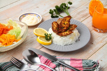 Freshly cooked honey mustard chicken breast served with rice and orange juice