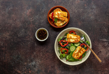 Green vegetarian salad from green leaves mix, vegetables, and halloumi cheese. Healthy recipe.
