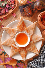 Fried moon shape shrimp cake with sauce on wooden table