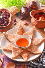 Fried moon shape shrimp cake with sauce on wooden table