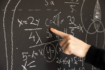 Mathematical formulas on dark black chalk board