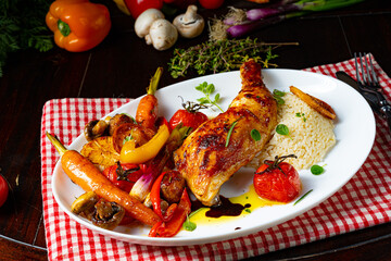 Rustic fried chicken legs with assorted vegetables and rice