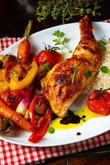 Rustic fried chicken legs with assorted vegetables and rice