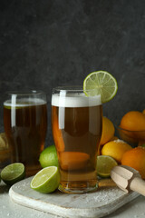 Beer with citrus against gray textured background