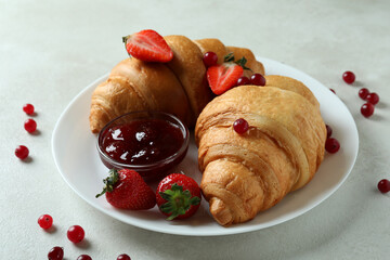 Concept of tasty breakfast with croissants on white textured table