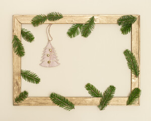 Christmas old wooden frame with green fir tree branches, golden christmas balls. Happy New Year holiday background.