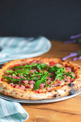 Pizza with seafood and arugula over rustic wooden background. Italian cuisine concept, Italian food.