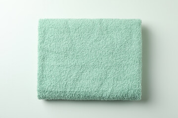 Clean green folded towel on white background