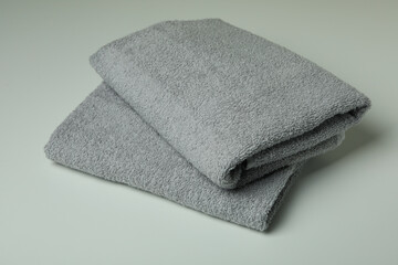 Fototapeta na wymiar Clean folded towels on light gray background, close up