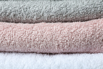 Fototapeta na wymiar Clean folded towels on whole background, close up