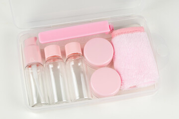 Travel small bottle set, in transparent cosmetic bag on a white background