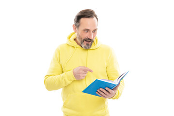 caucasian man in yellow hoody planning his work. adult guy reading planner. agenda.