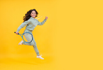 happy energetic child jump with tennis racquet running to success, copy space, sport shopping sale.