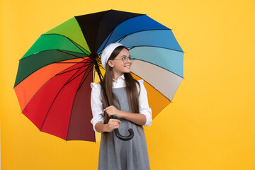 happy teen girl in beret under colorful umbrella for rain protection in autumn season, childhood.