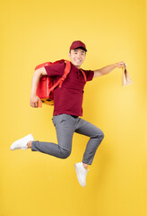 Fototapeta na wymiar Asian delivery man wearing a red uniform posing on yellow background