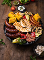 Grilled sausages, meat, and vegetables.