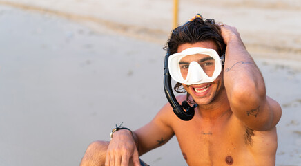 Young caucasian man getting ready to dive into the sea