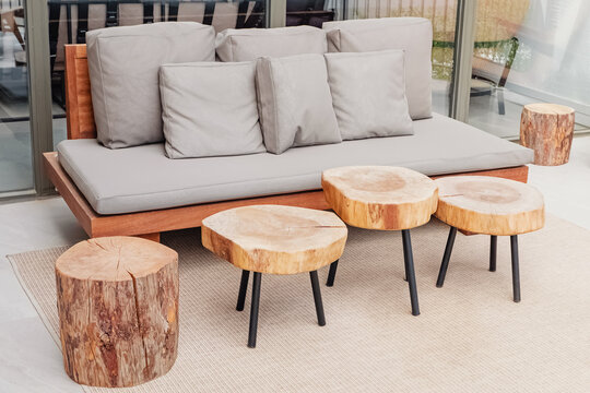 Wooden sofa and coffee tables on stylish modern terrace