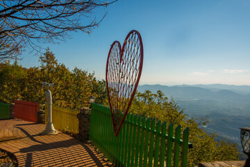 TIRANA, ALBANIA: A huge heart and a colorful fence with lanterns in the park on the observation...