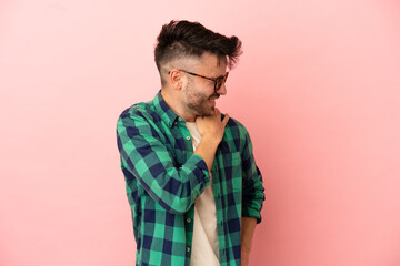Young caucasian man isolated on pink background suffering from pain in shoulder for having made an effort