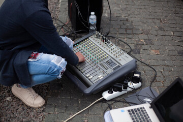 The sound engineer adjusts the sound on the remote control