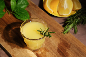 Alcoholic lemon drink limoncello. Shot glass of limoncello on table.