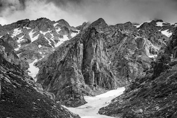 Black white mountains of rock snow and clouds