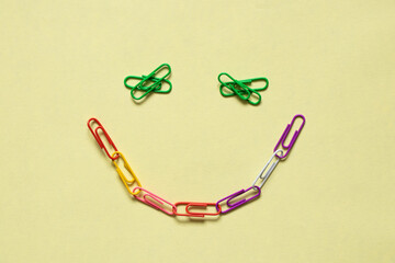 smiley from multicolored paper clips on an isolated background