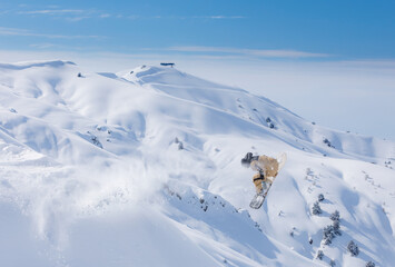 Snowboarder jumps in fresh snow