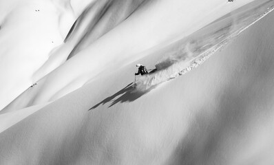 Skier rides on fresh snow black white