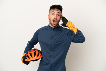 Young cyclist man isolated on white background with surprise expression - obrazy, fototapety, plakaty