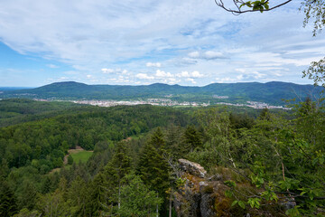 beautiful panarama view from a mountain with forest imposing rocks and under blue sky