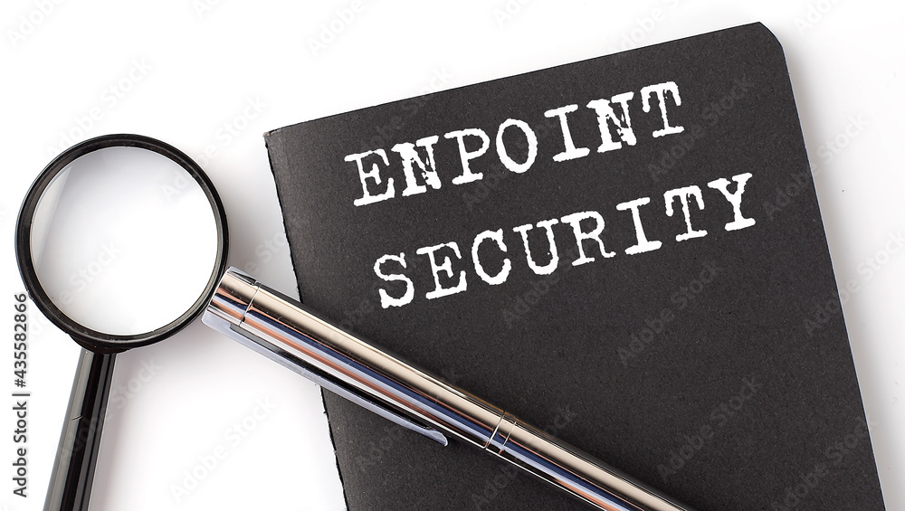 Poster endpoint security - business concept, magnifier with white text message on black notebook