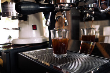 Fresh espresso shot pouring out of machine.