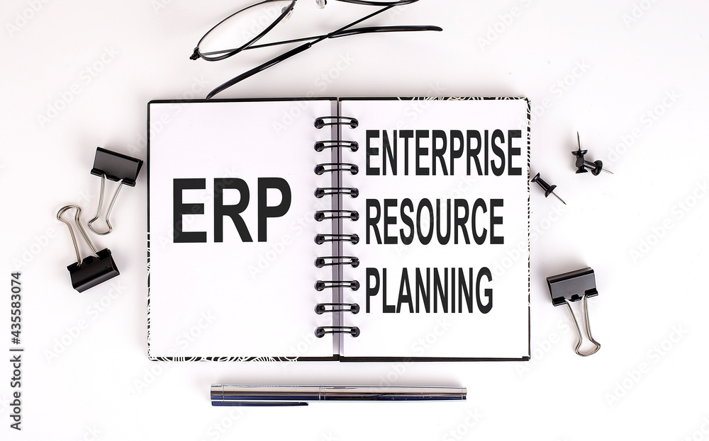 Poster notebook with erp on table with office tools