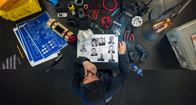 Bomber looks at a photo of the victim and counts the notes.