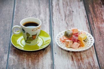 black turkish coffee in a cup and sweet oriental lukum