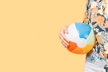 unknown woman with summer clothes holding an inflatable banana
