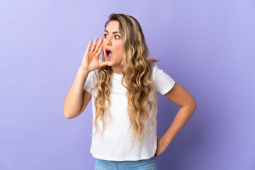 Young Brazilian woman isolated on purple background shouting with mouth wide open to the side