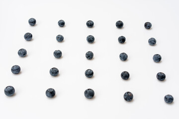 Blueberries are neatly arranged on a white background