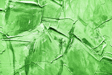 Green paint stucco wall texture. Concrete surface background. Color plaster wall pattern. Artistic smudges of plaster on the wall. Decorative wall paint technique.