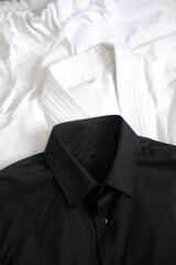 White kimono for karate training. Next to it is a black classic shirt