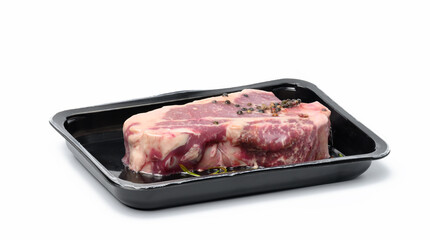 Raw New York beef steak is packed in a plastic container and vacuum sealed. Long-term storage striploin meat