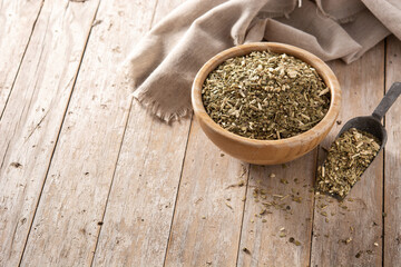 Traditional yerba mate tea in bowl on wooden table. typical Argentine drink.Copy space
