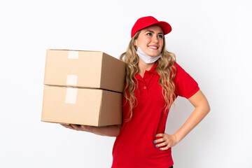 Food delivery Brazilian woman isolated on white background posing with arms at hip and smiling