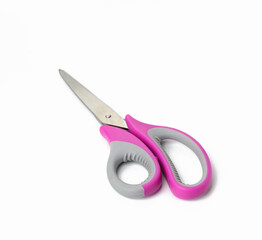 metal scissors with pink plastic handle for paper isolated on white background